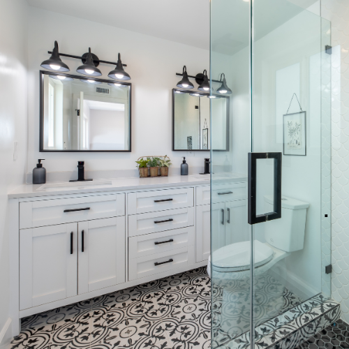 black and white guest bathroom remodel with sconce vanity lights