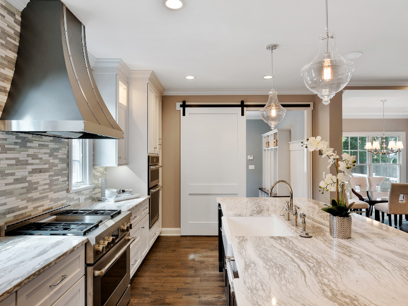 large kitchen with range hood, pendant lighting over island, recessed lighting and new appliances for CK electric blog