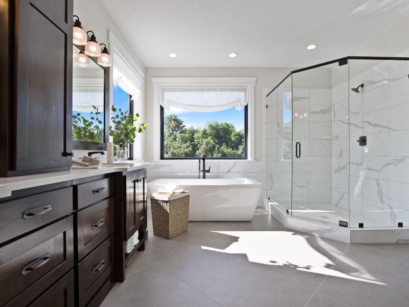 master bathroom with tub recessed lighting and sconce vanity lighting